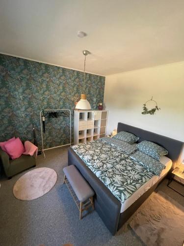 a bedroom with a bed and a chair in it at am Conradhof in Goch