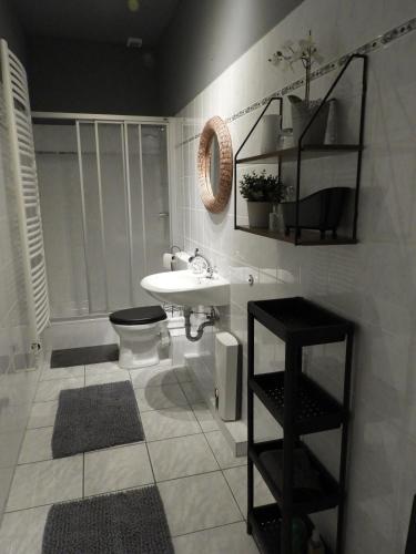 a bathroom with a white sink and a toilet at am Conradhof in Goch
