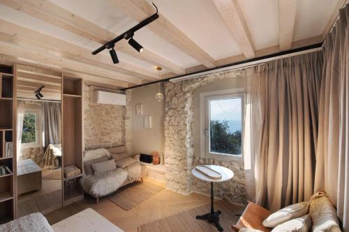 a living room with a stone wall at Cozy Sommavilla Residence in Brenzone sul Garda