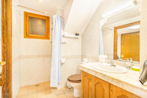 a bathroom with a sink and a toilet and a mirror at Cal Confianza in Borredá
