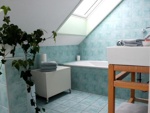 a bathroom with a sink and a bath tub at Ferienwohnung auf der Baar in Bad Dürrheim