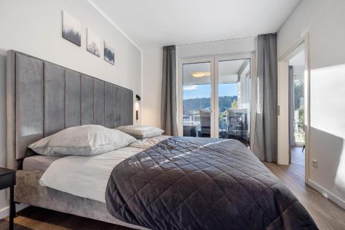 a bedroom with a large bed with a large headboard at Egge Resort 7a mit Whirpool u Sauna in Altenbeken
