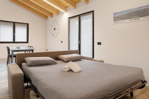 a bedroom with a bed with two pillows on it at Appartamento Alice in Caiolo