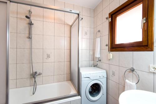 a bathroom with a shower and a washing machine at Best place Playamar in Torremolinos