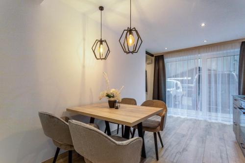 a dining room with a wooden table and chairs at Grauzone Grossarl App Nr 1 Cozy in Grossarl