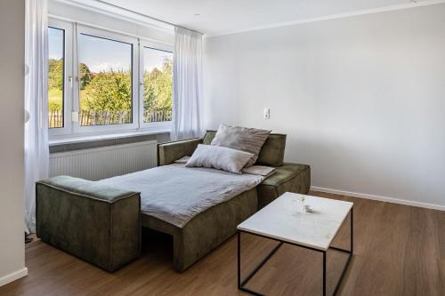 a living room with a couch and a table at Zimis Hofnest in Freiamt
