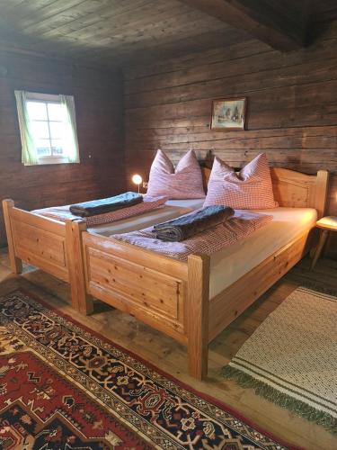 a bedroom with a large wooden bed in a room at Adlerhütte in Stall