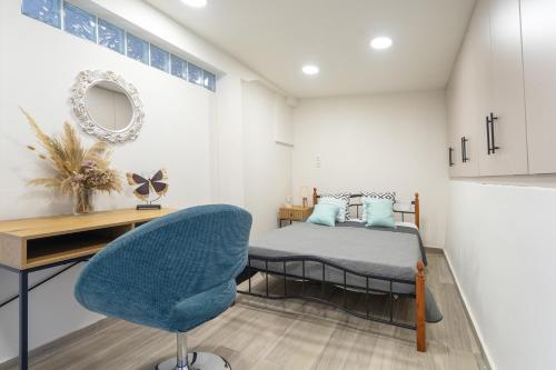 a bedroom with a bed and a desk and a chair at Villa Andreas in Athani