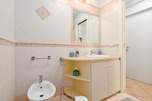 a bathroom with a sink and a mirror at Casa Ioana in Cugnana Verde