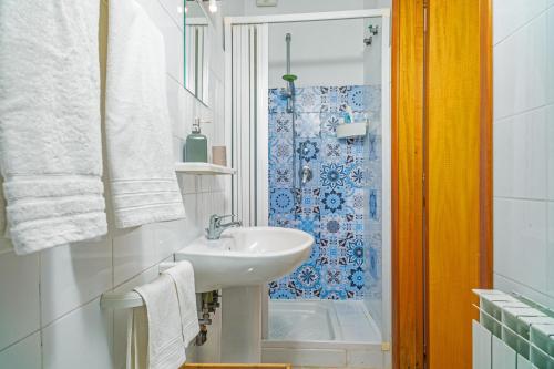 a bathroom with a sink and a shower at Casa Idda in Linguaglossa