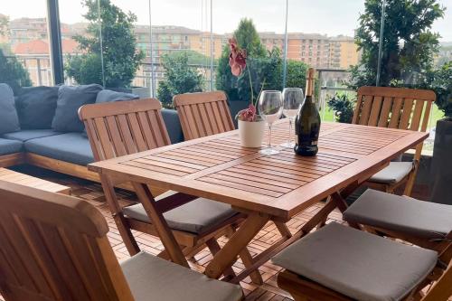 a wooden table with chairs and a bottle of wine at Fiorucci Apartments - Veronica's House in Rome