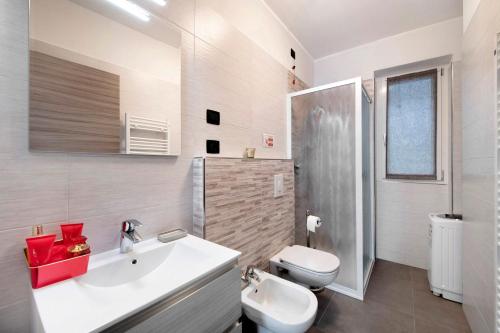 a bathroom with a white sink and a toilet at Appartamento 1 Il Tornante in Nesso