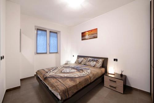 a bedroom with a large bed in a white room at Appartamento 1 Il Tornante in Nesso