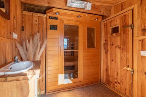 a bathroom with a sink and a shower in a cabin at Le Grand Mas de Can Noy in Montferrer