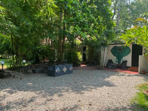 a yard with a building with a painting on the wall at Mint Inside Garden in Varkala