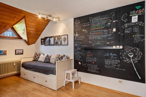 a room with a bed and a chalkboard wall at Appartement Seefreunde in Langenargen