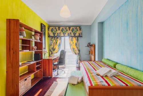 a bedroom with a bed and a desk in it at Setúbal Dreams in Setúbal