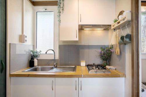 a small kitchen with a sink and a stove at La Breña in Barbate