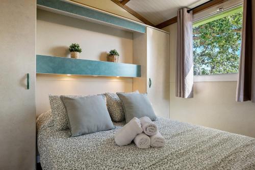 a bedroom with a bed with towels on it at La Breña in Barbate