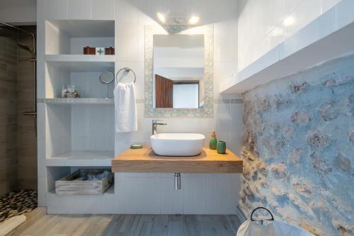 a bathroom with a sink and a mirror at Casa La Roca in Pollença