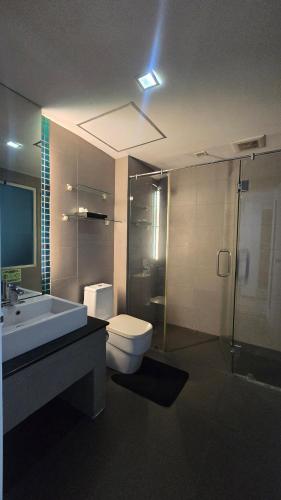 a bathroom with a toilet and a sink and a shower at joyful theKris 205 in Ban Lum Fuang