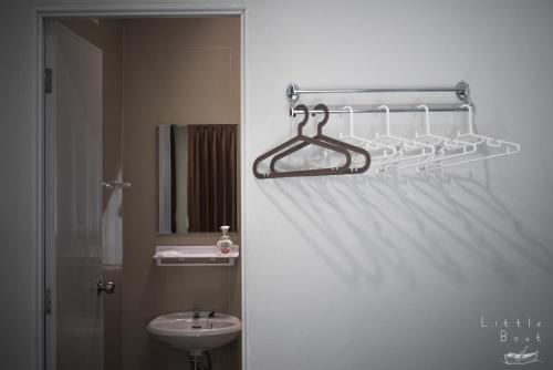 a bathroom with a sink and a toilet and a towel rack at Retro Twin Home @Maesot in Mae Sot