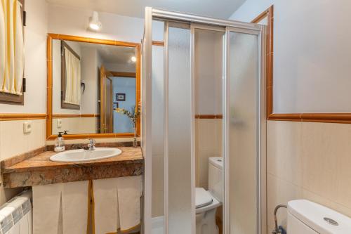 a bathroom with a sink and a shower at La Casa de Dafne Acebo in Santo Tomé del Puerto