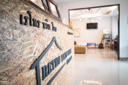 a sign on a wall in a living room at Retro Twin Home @Maesot in Mae Sot