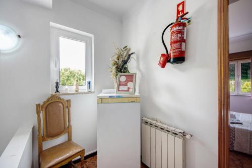 a room with a radiator and a fire extinguisher on the wall at Jorge Galinheiro Alojamento Local in Mamouros