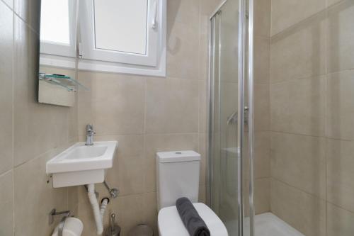 ein Badezimmer mit Toilette, Waschbecken und Dusche in der Unterkunft M5 room in Nikiana