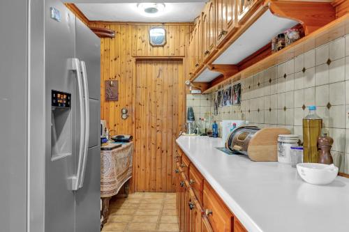 a kitchen with a white counter and a refrigerator at Barba Panais' House in Vonitsa