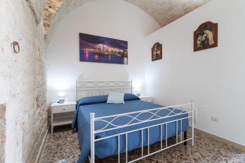 a bedroom with a bed in a white room at Corallo House in Polignano a Mare