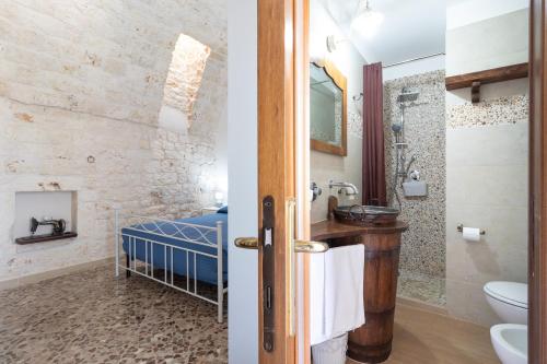a bathroom with a sink and a toilet and a shower at Corallo House in Polignano a Mare
