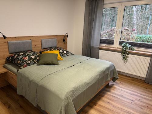 a bedroom with a bed and a window at Ahlers am Wald in Edewecht