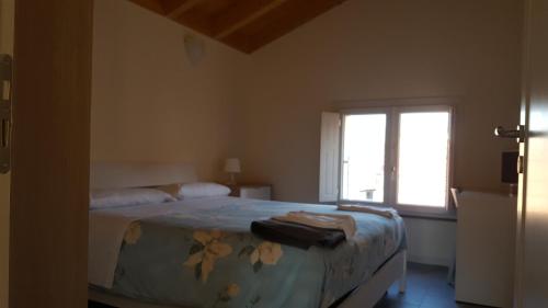 a bedroom with a bed and a window at La Tortora in Fisciano
