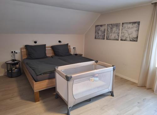 a small bedroom with a bed with a drawer at Pure Vista Hank Schwarzwaldblick in Luttingen