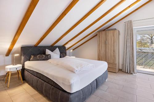 a bedroom with a large bed in a attic at Ferienwohnungen Martin Lafar in Öhningen