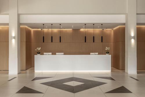 a lobby with a white table and chairs at Faros Hotel Ayia Napa in Ayia Napa