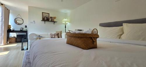 a bedroom with a bed with a basket on it at Ari & Alki Garden in Ban Nong Nam Khan