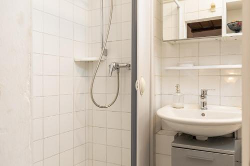 a white bathroom with a sink and a shower at Casa Al Cantone in Certaldo