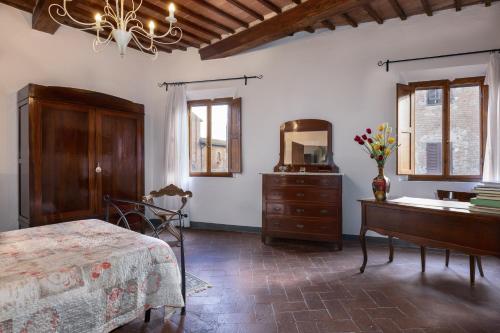 a bedroom with a bed and a dresser and a mirror at Casa Al Cantone in Certaldo