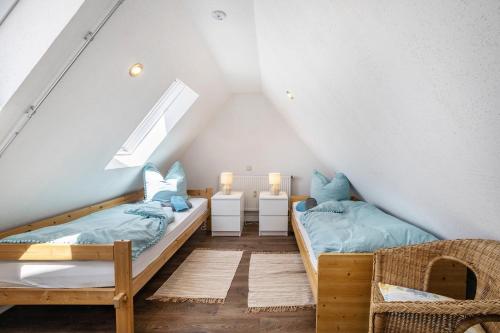 a attic bedroom with two beds and a window at Ferienwohnung Luna in Bindlach