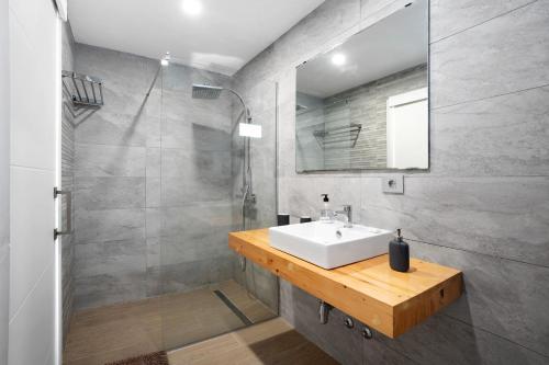 a bathroom with a white sink and a mirror at Casita El Pleito in Candelaria