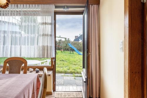 a dining room with a table and a sliding glass door at Haus Lahrsen in Wesselburen