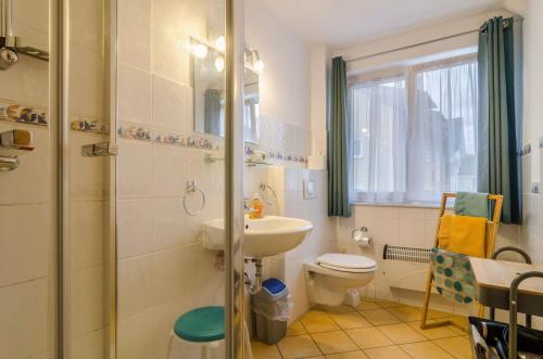 a bathroom with a sink and a toilet and a shower at Apfel in Meersburg