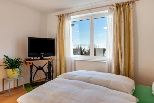 a bedroom with a bed in front of a window at Apfel in Meersburg