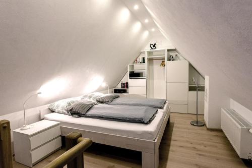 a small bedroom with a bed in a attic at Haus Schulz in Heide