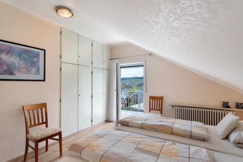 a bedroom with two beds and a window at Ferienhaus Lydia in Sasbach in der Ortenau