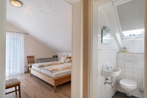 a bedroom with a bed and a sink at Ferienhaus Lydia in Sasbach in der Ortenau