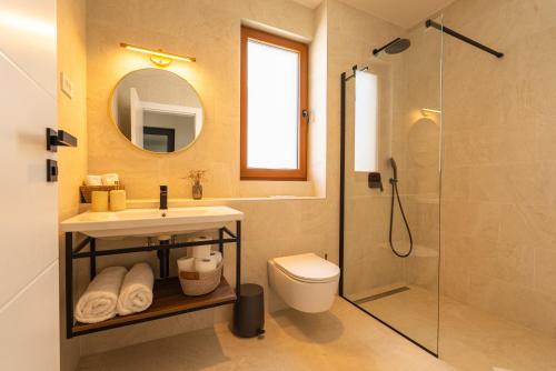 a bathroom with a sink and a toilet and a shower at Kožino Bay Lodge - Brand New Seaside Apartments, Heated Pool in Kožino